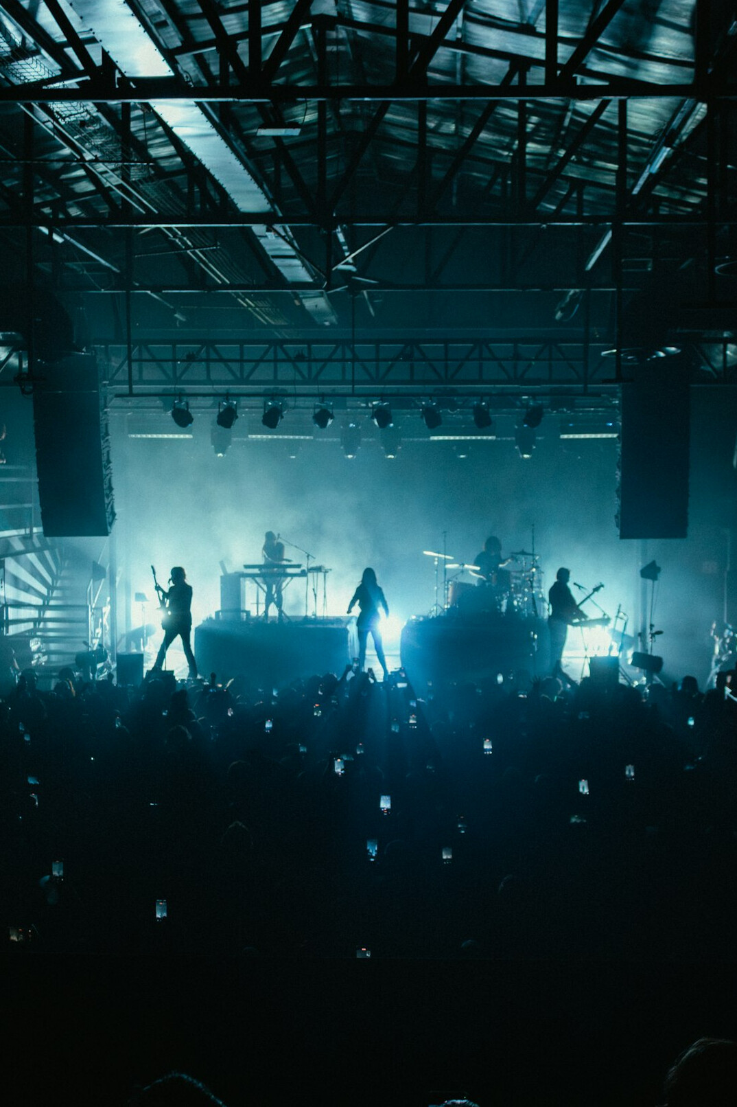 Stage lighting rig above a concert venue